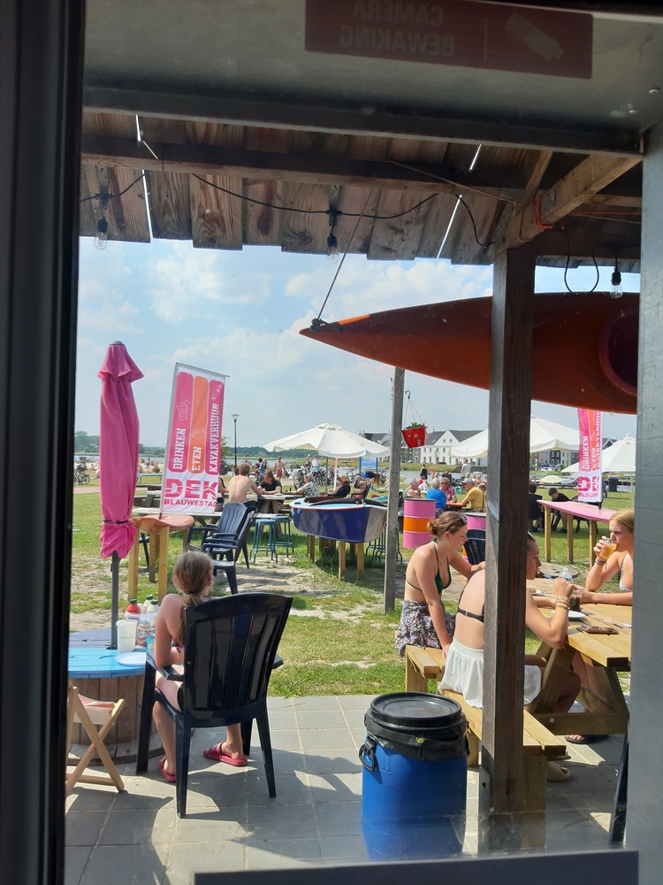 Drinken op het terras van DEK Blauwestad aan Strand Zuid met uizicht over het Oldambtmeer